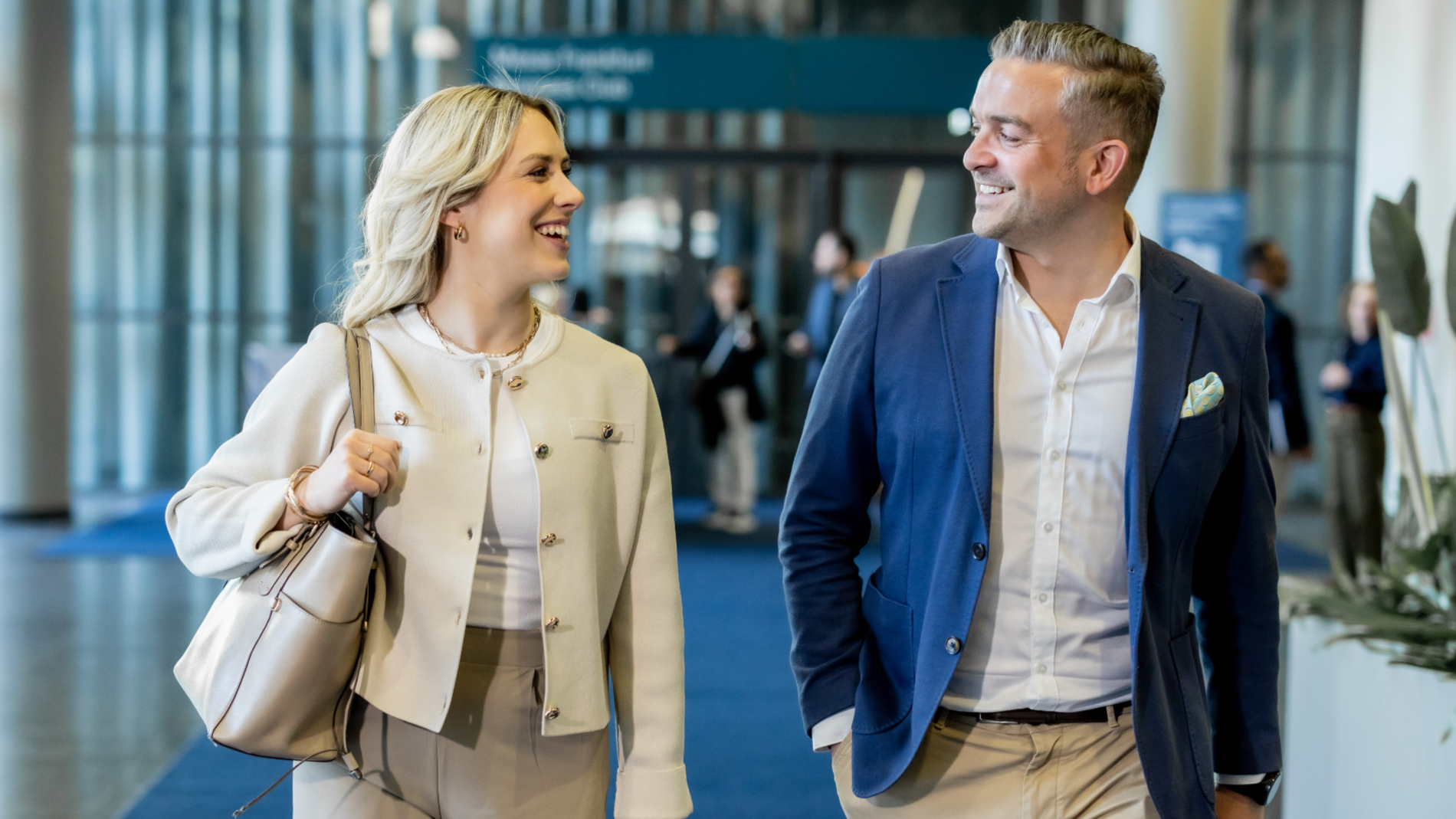 A woman and a man are chatting while walking.