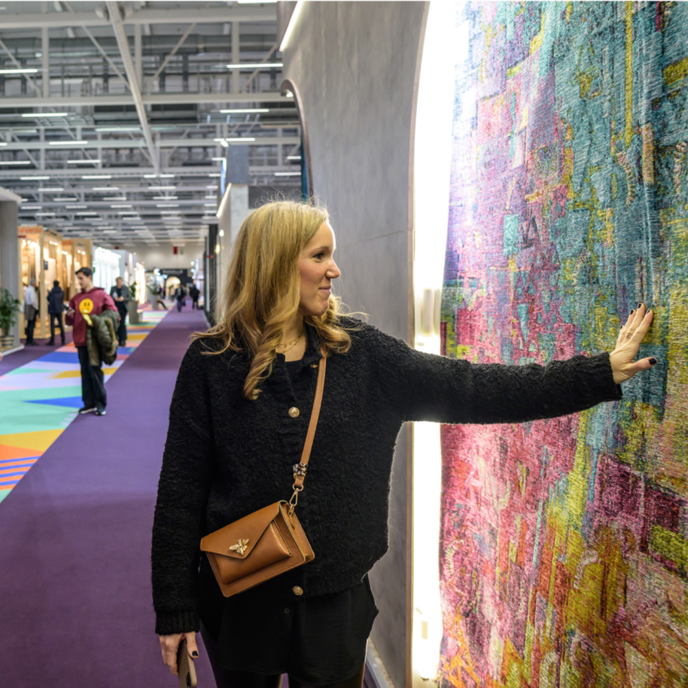 Heimtextil-Besuchering vor einem Teppich