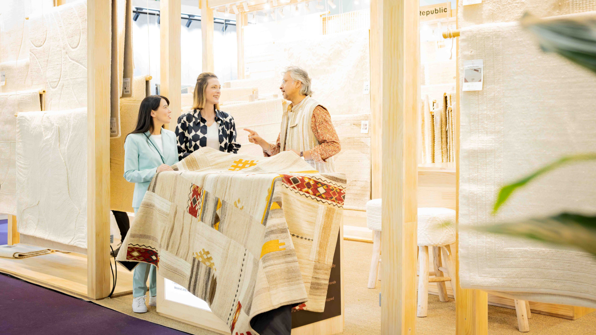 Visitors and exhibitors looking at carpets