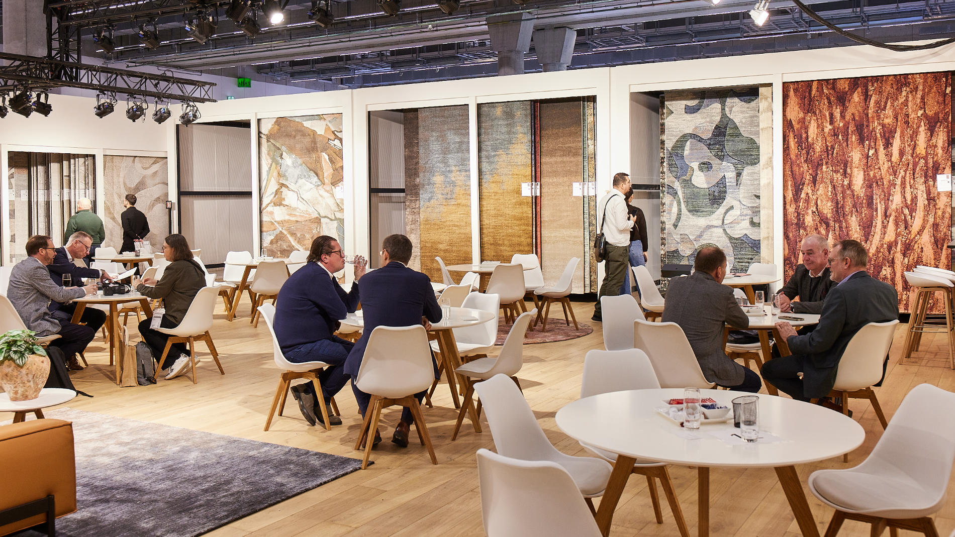 Exhibitors and visitors sitting at a stand