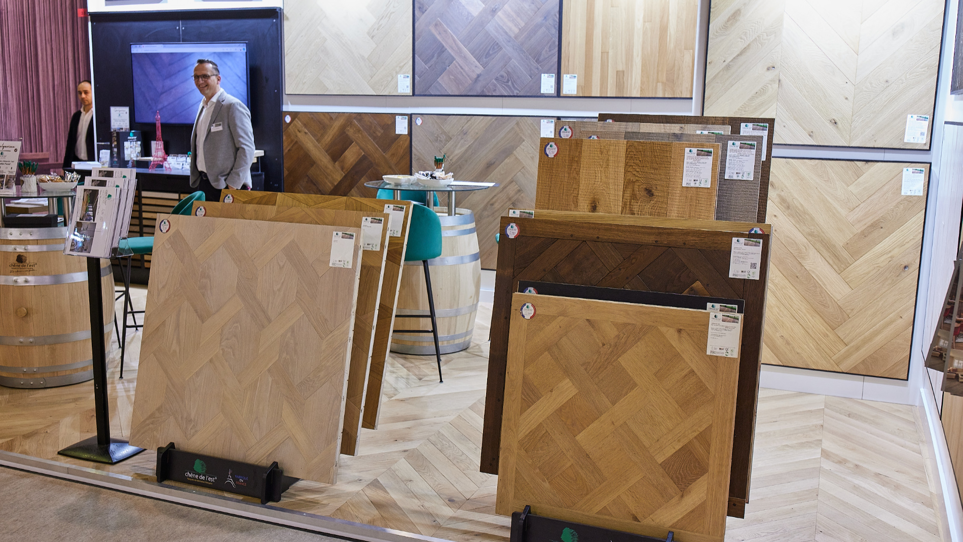 Display of various wood and parquet samples at an exhibition booth