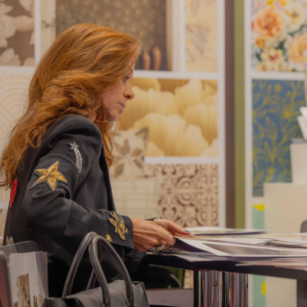 Woman is looking at wall paper designs